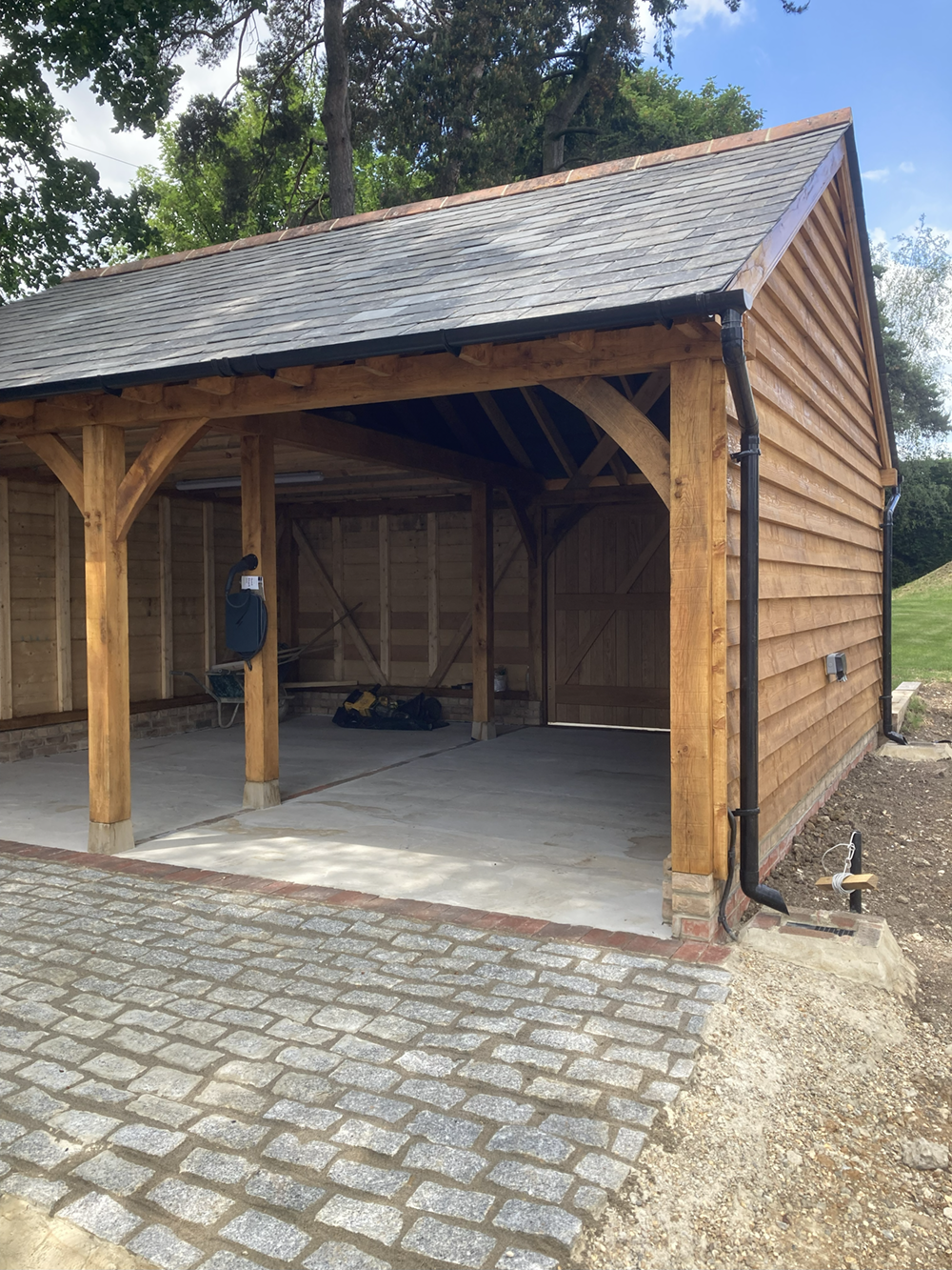 Granite sett cobble driveway with oak frame carport and slate roof